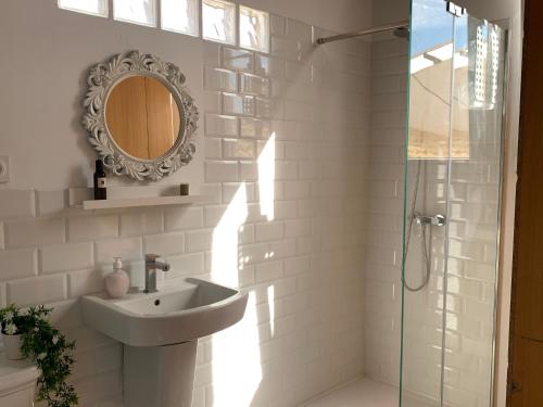 a white bathroom with a sink and a mirror at Rest Valencia in Valencia