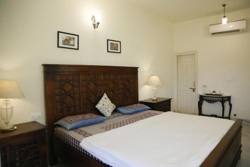 a bedroom with a large bed and two night stands at Jai Villa Homestay in Udaipur