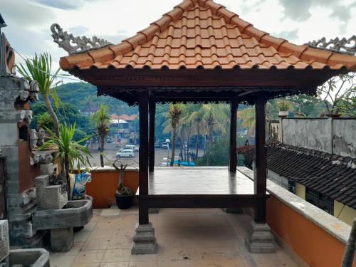 a gazebo on the roof of a building at Harmony Guest House in Padangbai
