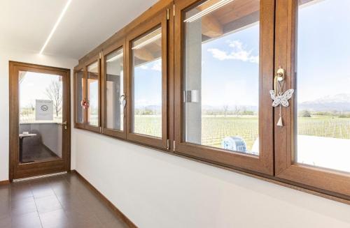 a room with windows with a view of a field at AGRITURISMO DA LAURA in Povoletto