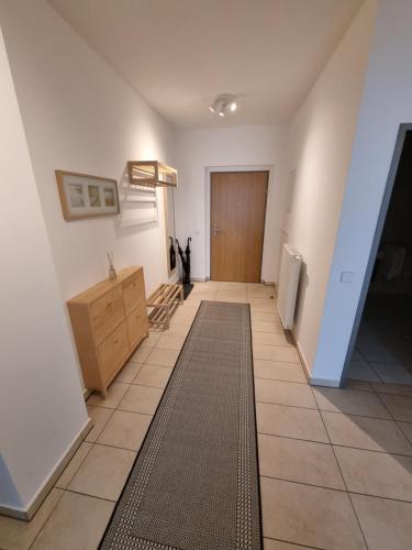 a hallway with a door and a tiled floor at City Appartements Villach in Villach