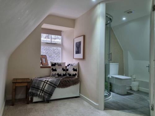 a bathroom with a shower and a bench and a sink at Historic cottage next to loch lomond Luss in Alexandria