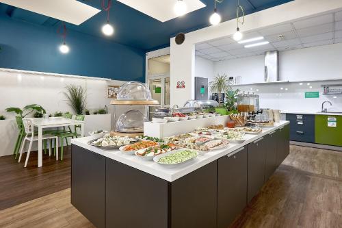 a buffet line with many plates of food at Hotel Traffic Poznań Stare Miasto in Poznań