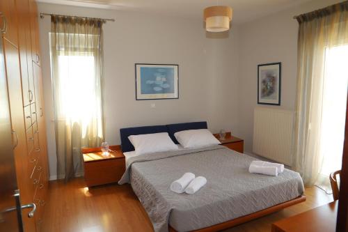 a bedroom with a bed with two white towels on it at Evimerou Villa in Kos