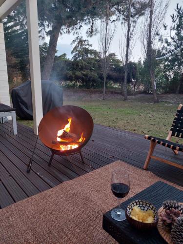 a fire pit on a deck with a glass of wine at Villa Mar in Troia