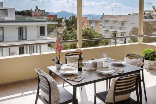 a table and chairs on a balcony with a view at Sea view penthouse in Vari in Vari