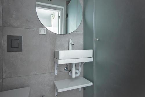 a bathroom with a sink and a mirror at Sun Lovers Hostel in Albufeira
