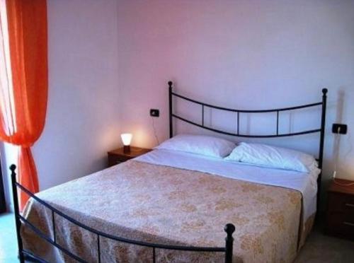 a bedroom with a large bed with a black frame at Agriturismo L'Erpice in Francavilla al Mare