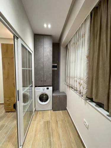 Un lavadero con lavadora y secadora. en Modern 1 Bedroom City Apartment, en Tirana