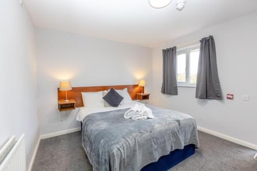 a bedroom with a bed and a window at The Angel Hotel in Alton