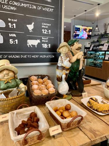 a counter with baskets of food and figurines on it at Leva Hotel and Suites, Opposite Downtown in Dubai
