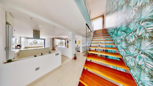 a staircase in a house with a mural on the wall at Villa Lili in L'Ampolla