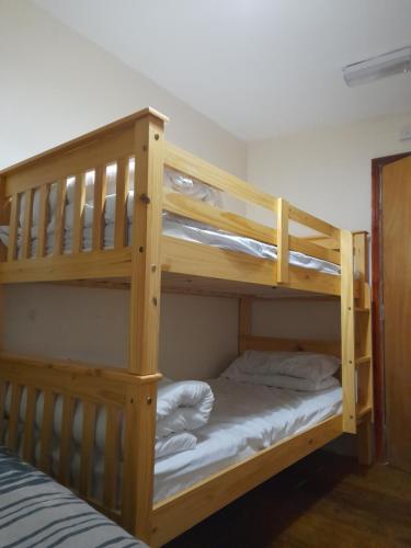 two bunk beds in a room with a bed at Bubblesbnb, 1 bedroom flat in London