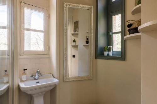 a bathroom with a sink and a mirror at Chateau LE BROSSAY in Renac