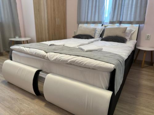 duże łóżko z białą pościelą i poduszkami w obiekcie Utopia Apartment 1, by LMG w mieście Chisaria