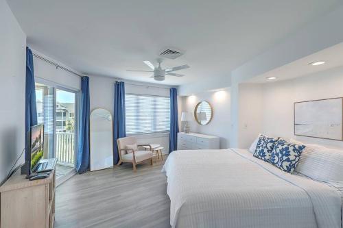 a bedroom with a bed and a television in it at Port O' Call E302 - Top Floor Ocean View Condo! in Isle of Palms
