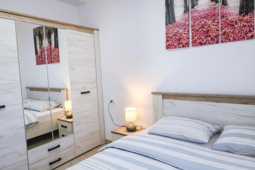 a bedroom with a bed and a mirror at Apartments Mirela in Koper