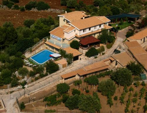 an aerial view of a house with a swimming pool at Fattoria Terra e Libertà in Contrada Maeggio
