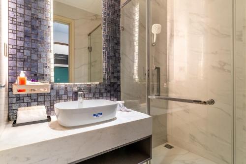 a bathroom with a sink and a shower at De Lux Central Studio next Hyatt ,Opera House ,Benthanh ,Pool,Gym in Ho Chi Minh City
