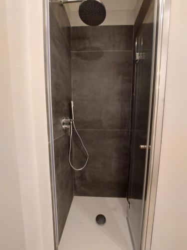 a shower with a glass door in a bathroom at Villa with private pool and garden in Tradate