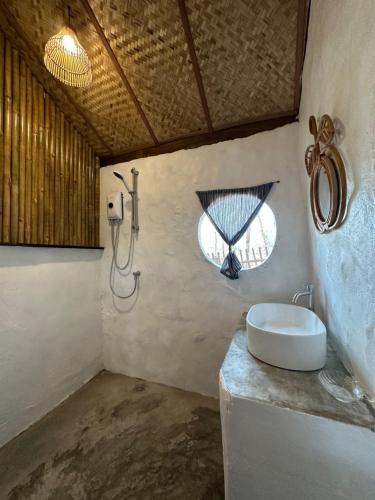 a bathroom with a sink and a shower at La Maison - Chiangmai in Mae Taeng