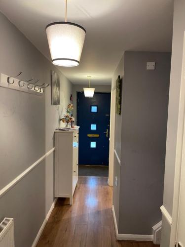 a hallway of a home with a blue door at Southend Lane Suites in Forest Hill
