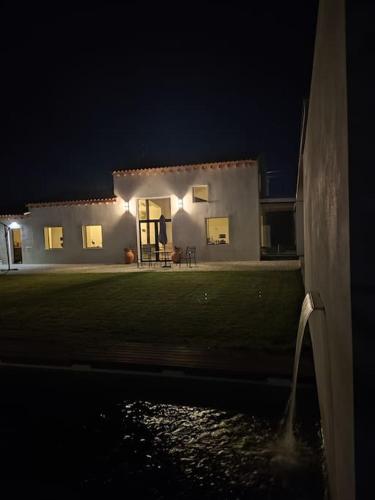a house at night with the lights on at Casa do Carvalhal - Quinta do Soldado in Alquerubim
