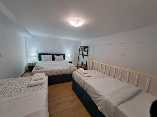 Ένα ή περισσότερα κρεβάτια σε δωμάτιο στο Pension Hirolakas