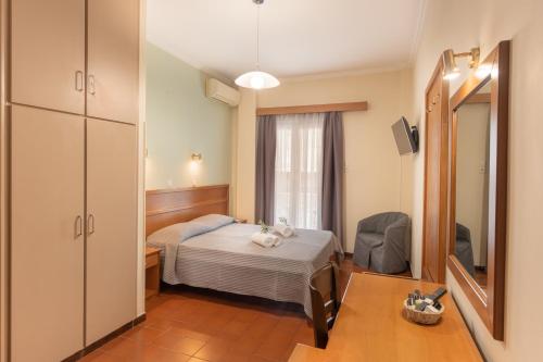 a hospital room with a bed and a mirror at Lesvion Hotel in Mytilene