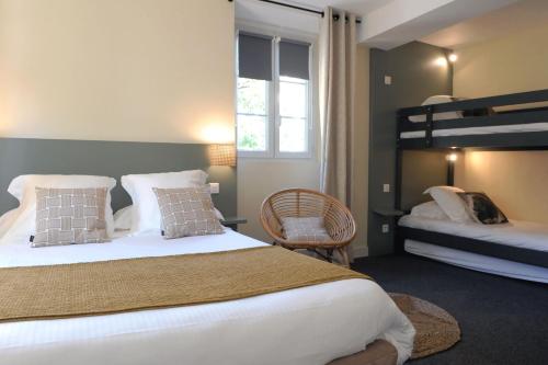 a bedroom with two beds and a bunk bed at Logis Hôtel du Chêne in Itxassou