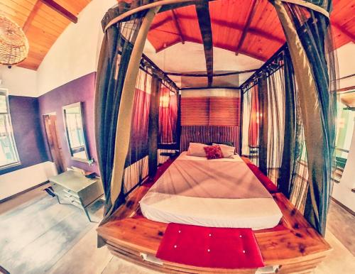 A bed or beds in a room at Red Coconut Villa