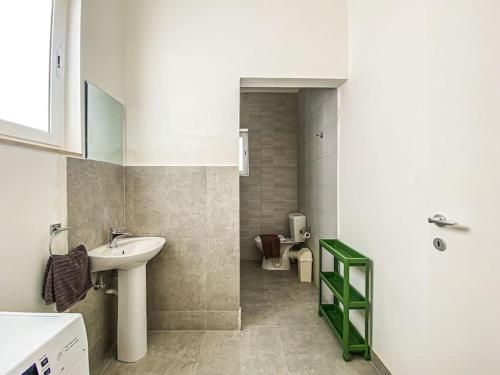 a bathroom with a sink and a toilet at Spacious 1 bedroom apartment in Gzira 5 in Il-Gżira