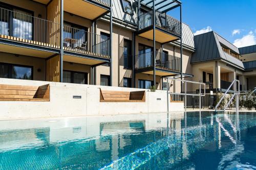 a swimming pool in front of a building at Aparthotel Bad Radkersburg in Bad Radkersburg