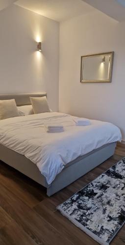 a bedroom with a large bed with a mirror on the wall at MODERN House in Sighetu Marmaţiei