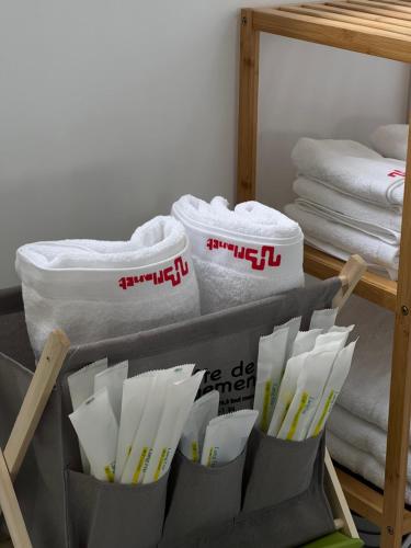 a group of folded towels and towels on a shelf at Planet 23 in Chiayi City