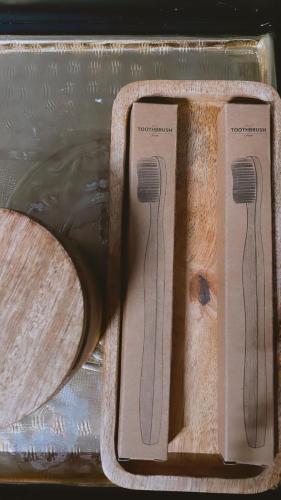 two wooden utensils in a container with water at Marina Zeas Seaside Studio-MarinaQ in Piraeus