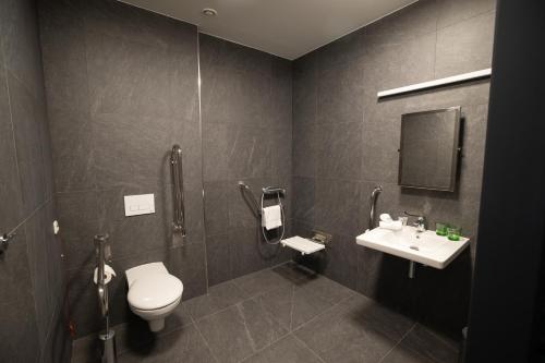 a bathroom with a toilet and a sink at Hotel Smetanova in Vsetín