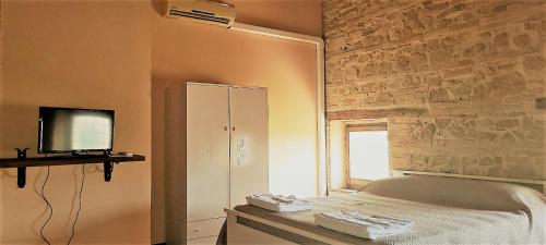 a bedroom with a bed and a mirror and a window at camere in Villa Luzi in Treia