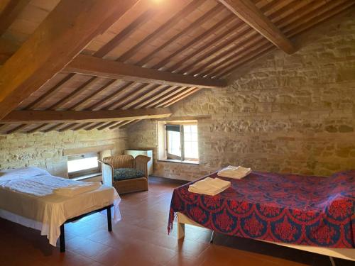 a room with a bed and a table in a building at camere in Villa Luzi in Treia