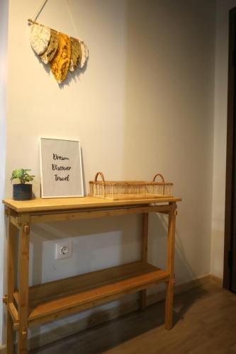 a wooden table with a sign on a wall at Marina Zeas Seaside Studio-MarinaQ in Piraeus