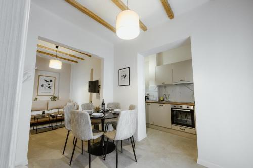 a kitchen and living room with a table and chairs at LB Luxury Apartments in Volos