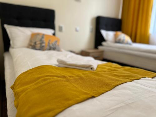 a yellow blanket laying on top of a bed at Utopia Apartment 2, by LMG in Hisarya