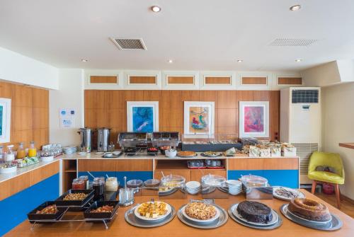 a large kitchen with a table full of food at Lesvion Hotel in Mytilene