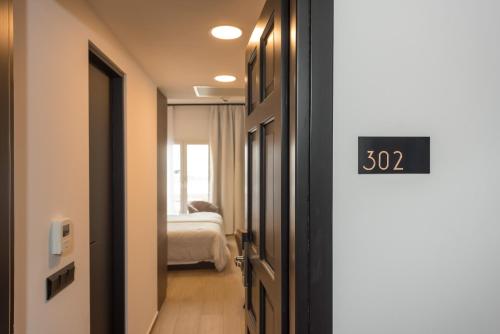 a room with a door with a clock on it at Lesvion Hotel in Mytilene