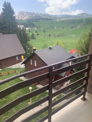 a view from the balcony of a house with a fence at Zlatni dar in Žabljak