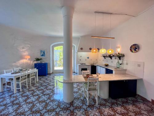 a kitchen and dining room with a table and chairs at Villa Izzo in Ischia