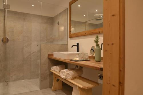 a bathroom with a sink and a shower at Landhaus Breitenberg in Lana