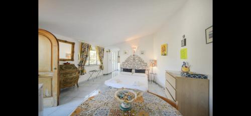 a bedroom with a bed and a table in a room at Villa Izzo in Ischia