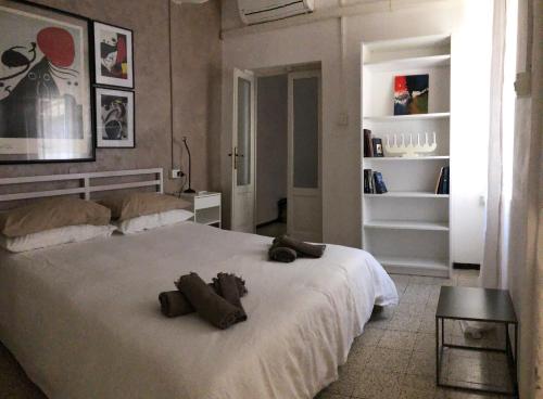 a bedroom with a bed with two stuffed animals on it at Bixio 81 in Parma