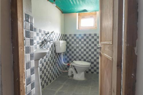 a bathroom with a toilet and a sink at MH - Pangong Homestay - B in Spangmik